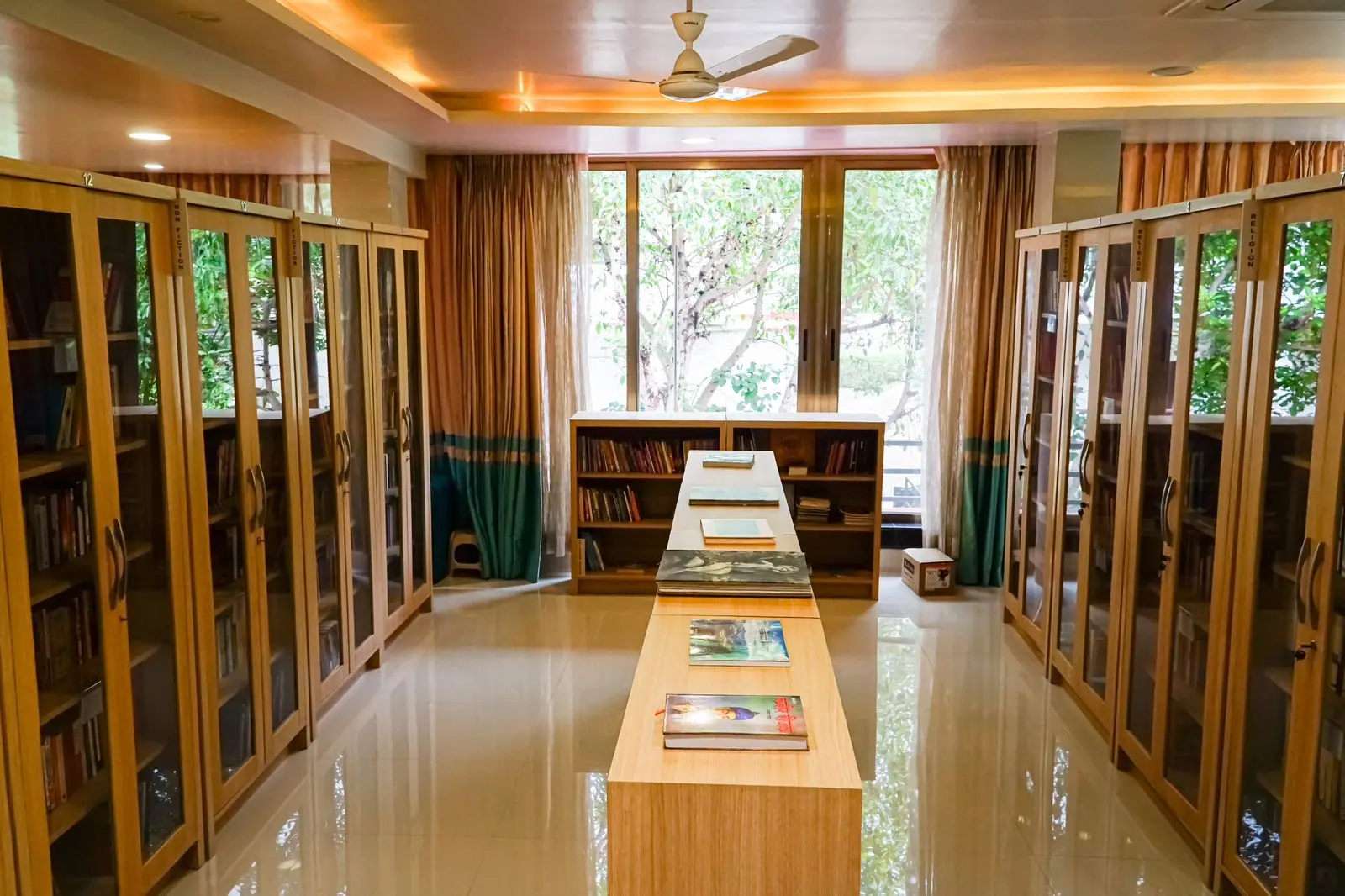 The library, glass-fronted shelves lining a bright room