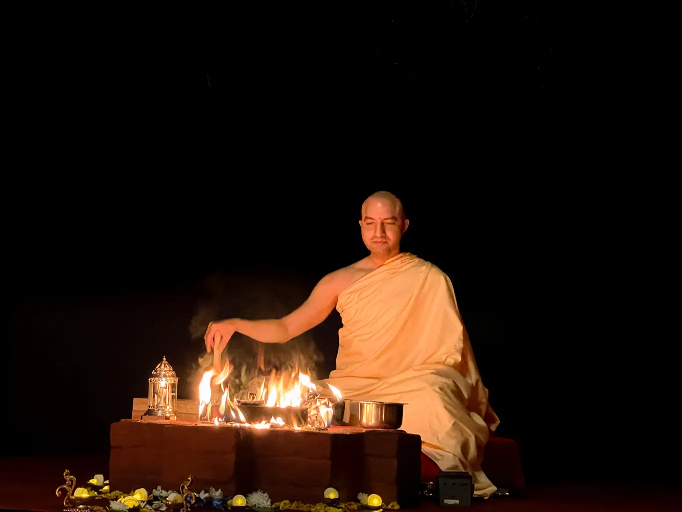 Om Swami offering into the sacred fire at night