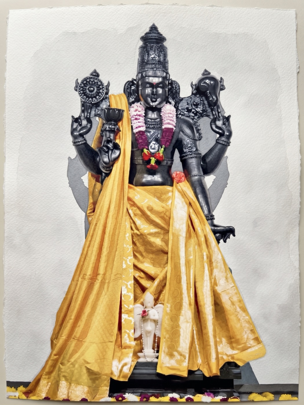 The idol of Sri Hari adorned in golden silk and garlands